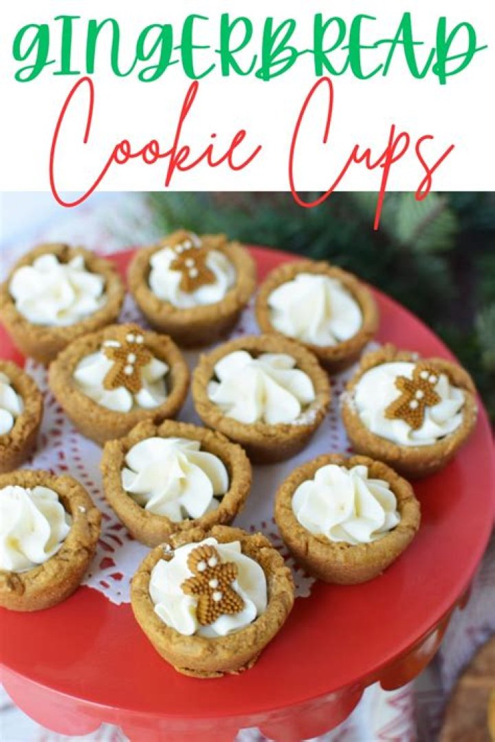 Gingerbread cookie cup topped with brown frosting on a white plate.