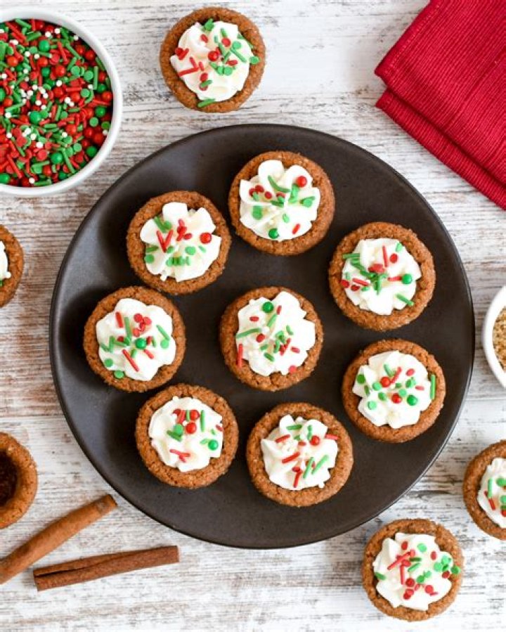 Gingerbread cookie cups in a muffin pan.
