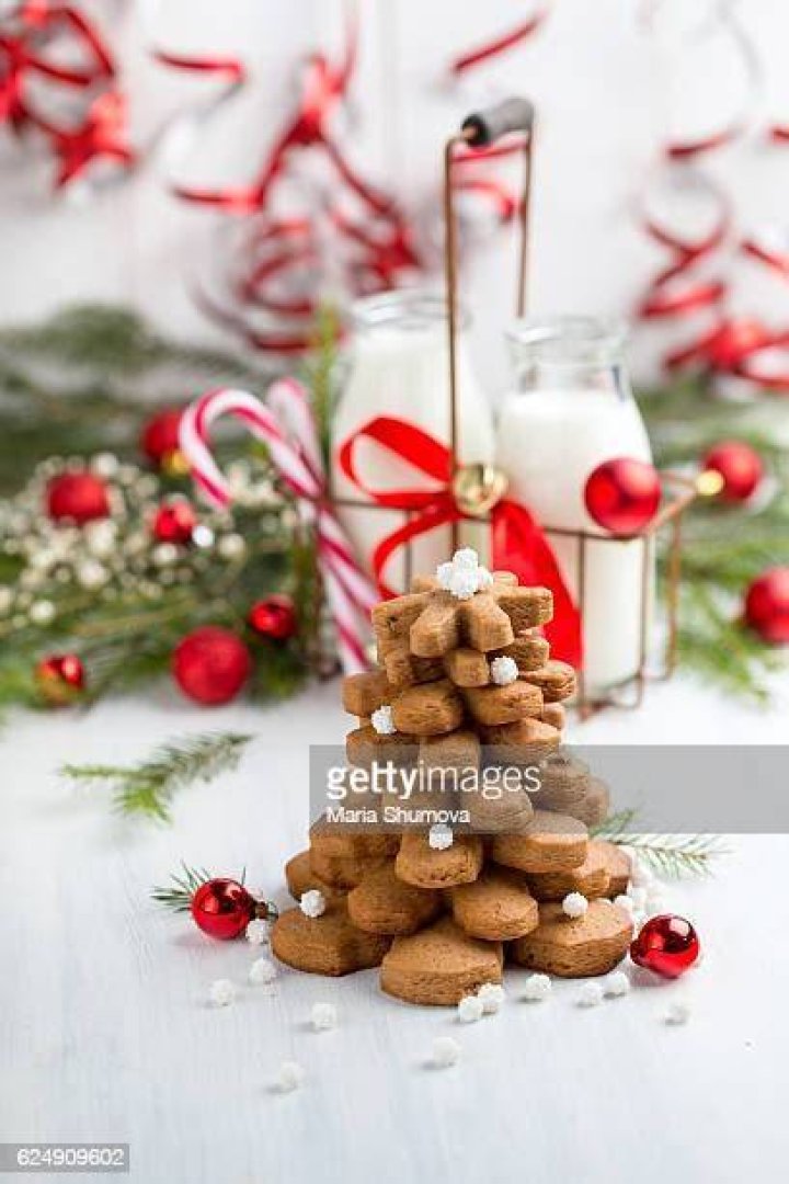 Stack of two gingerbread cookie cups with light brown frosting on top.